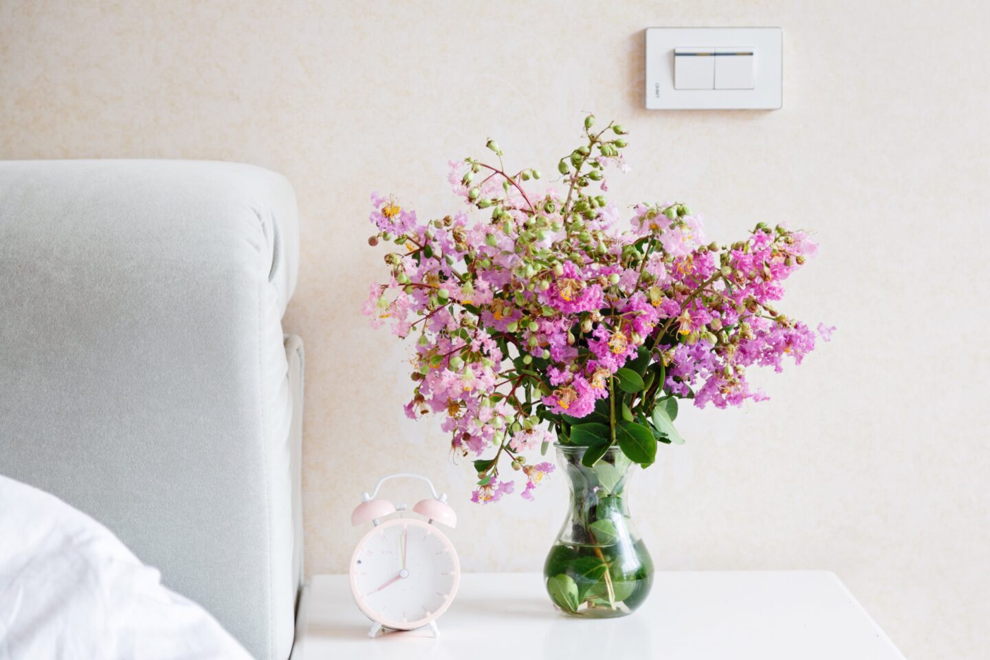 Fresh flowers on a nightstand are an easy and cheap home decor idea perfect for your bedroom.