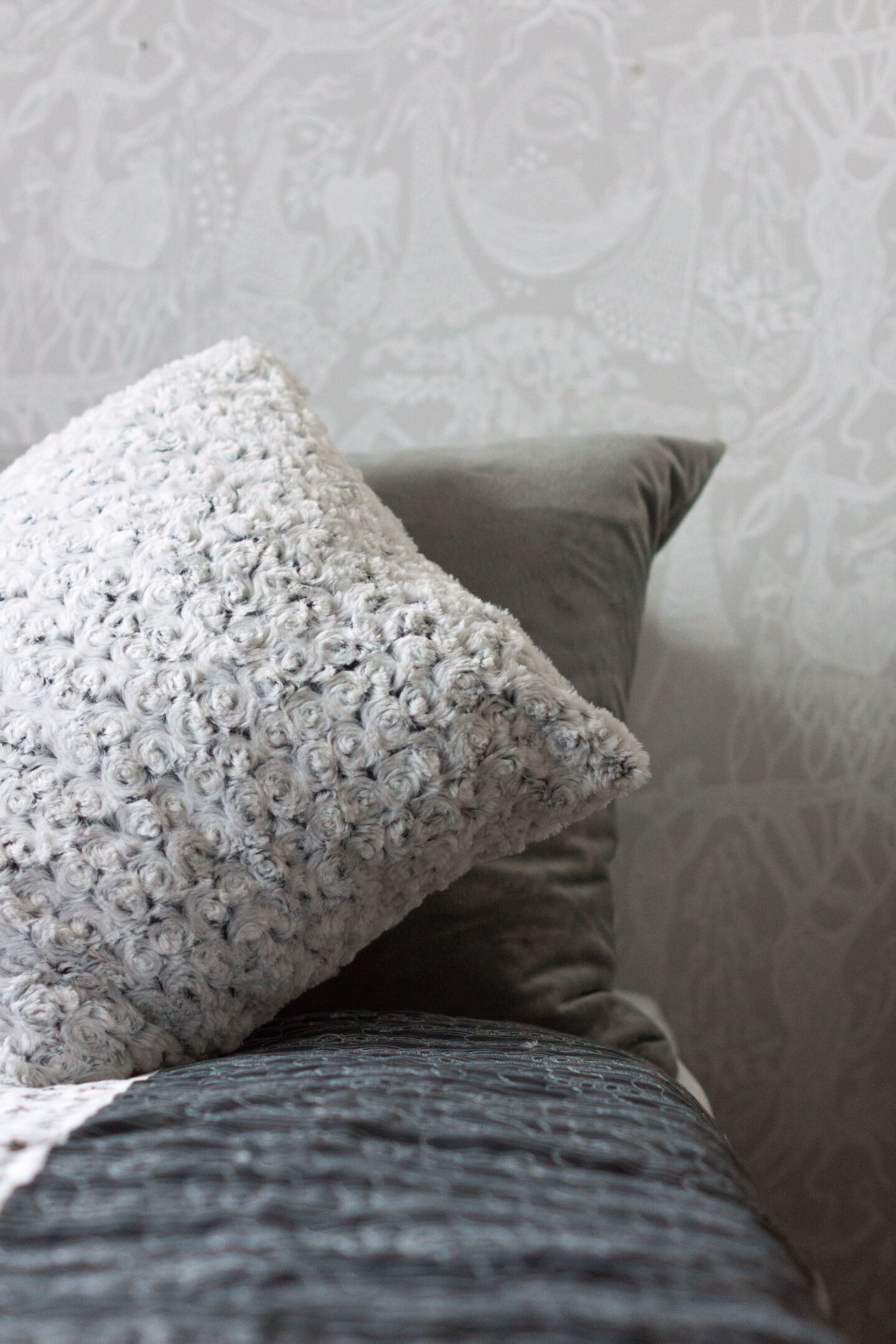 Wallpaper accent on a bedroom as a budget friendly way to decorate a room.